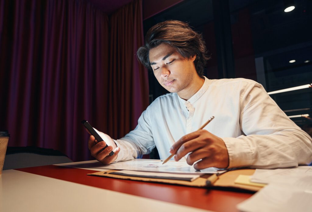 Serious man filling out questionnaire on workplace